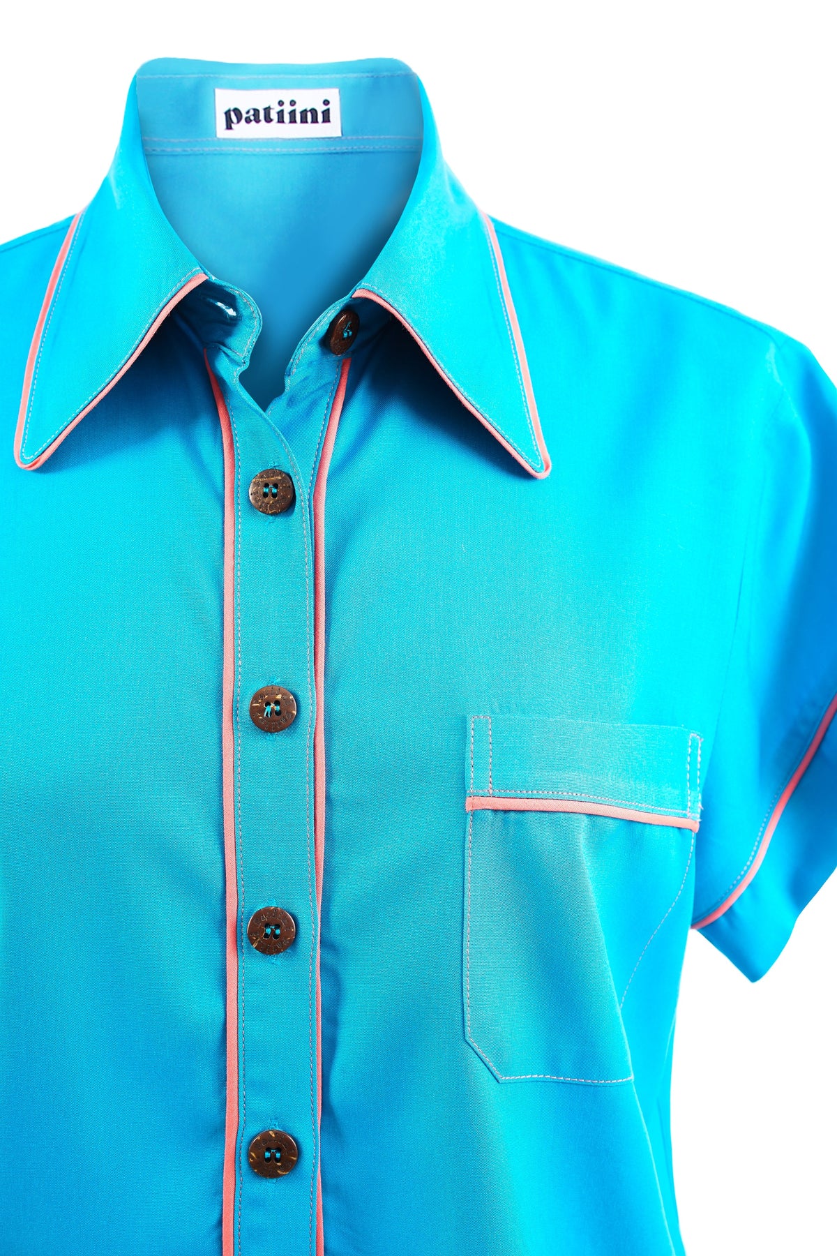 Close-up of a blue button-down shirt with coconut buttons.