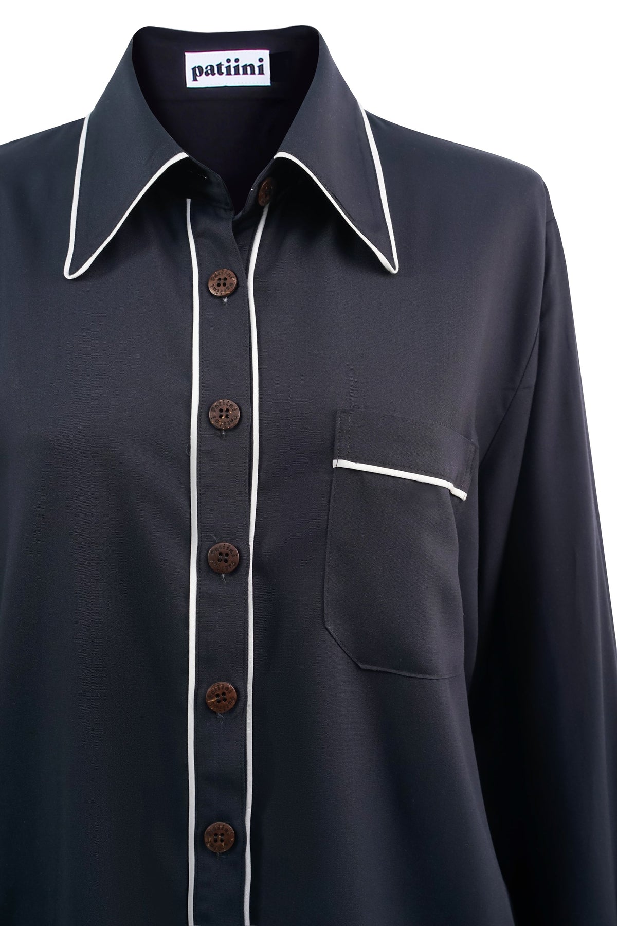 Close-up of a black long-sleeve button-down shirt with coconut shell buttons.