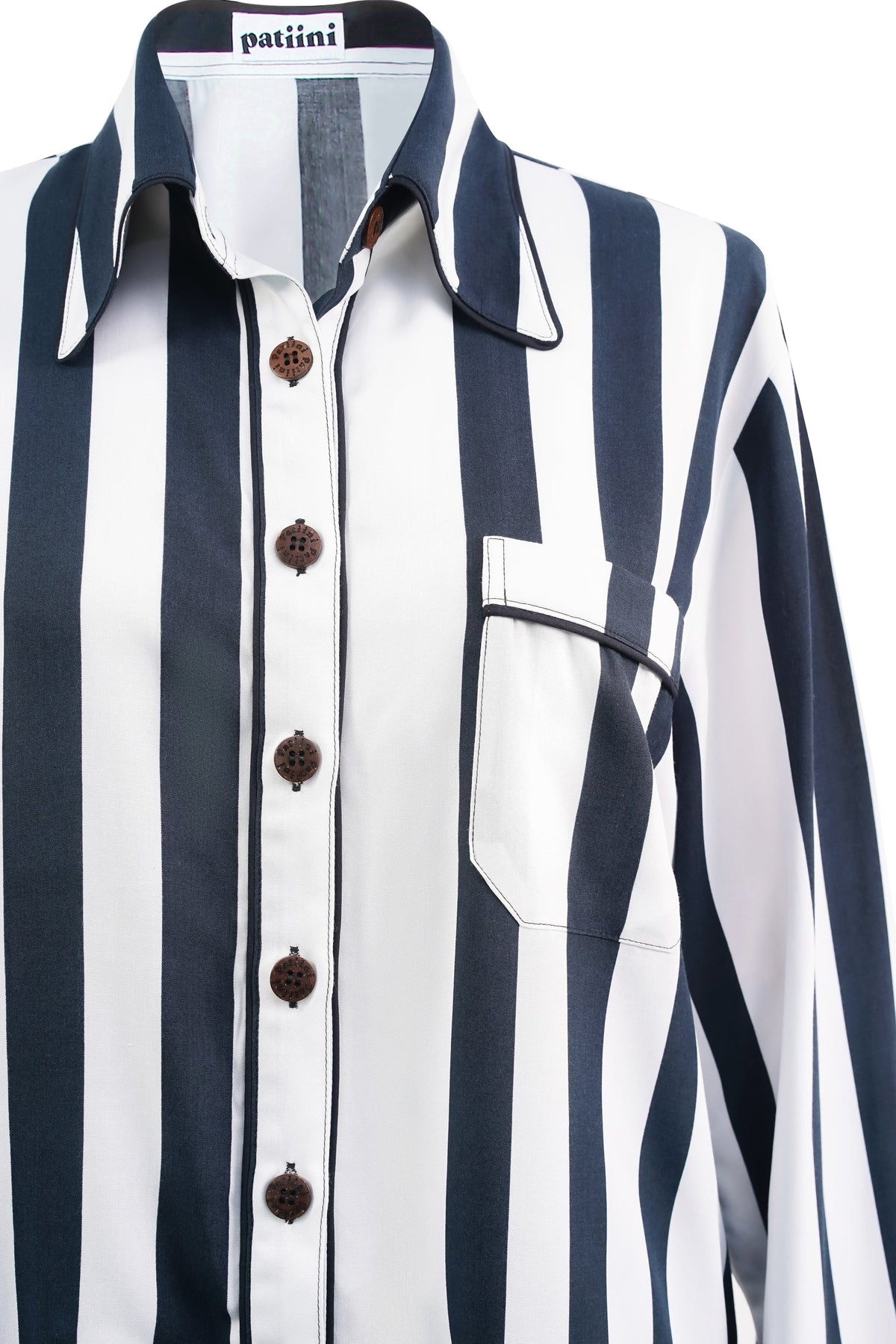 Close-up of a black and white striped long-sleeve shirt with coconut shell buttons.