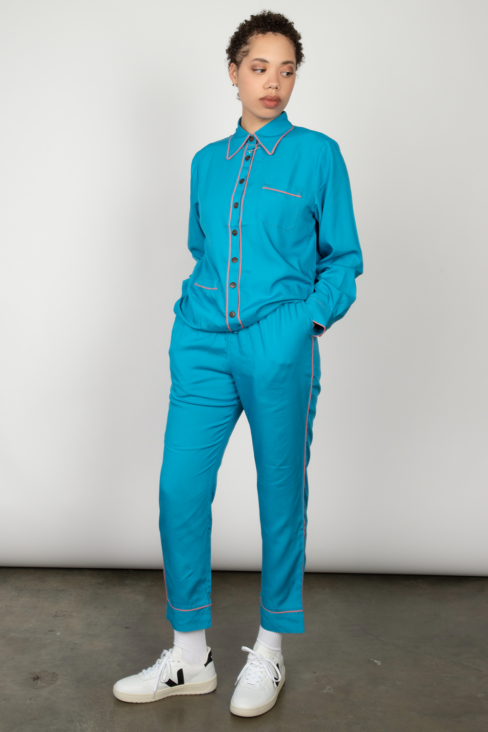 Woman wears a blue long-sleeved pajama set.