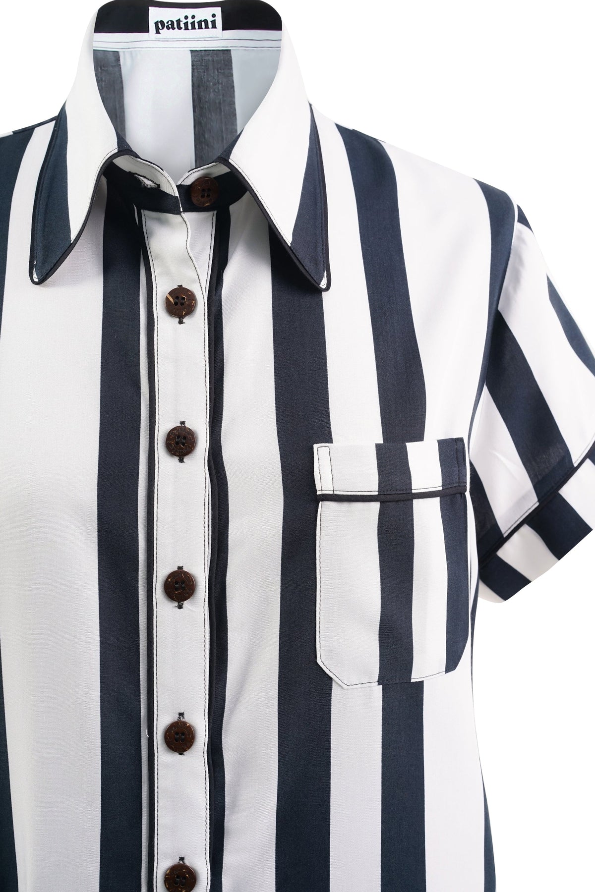 Close-up of a black and white striped button-down with coconut shell buttons.