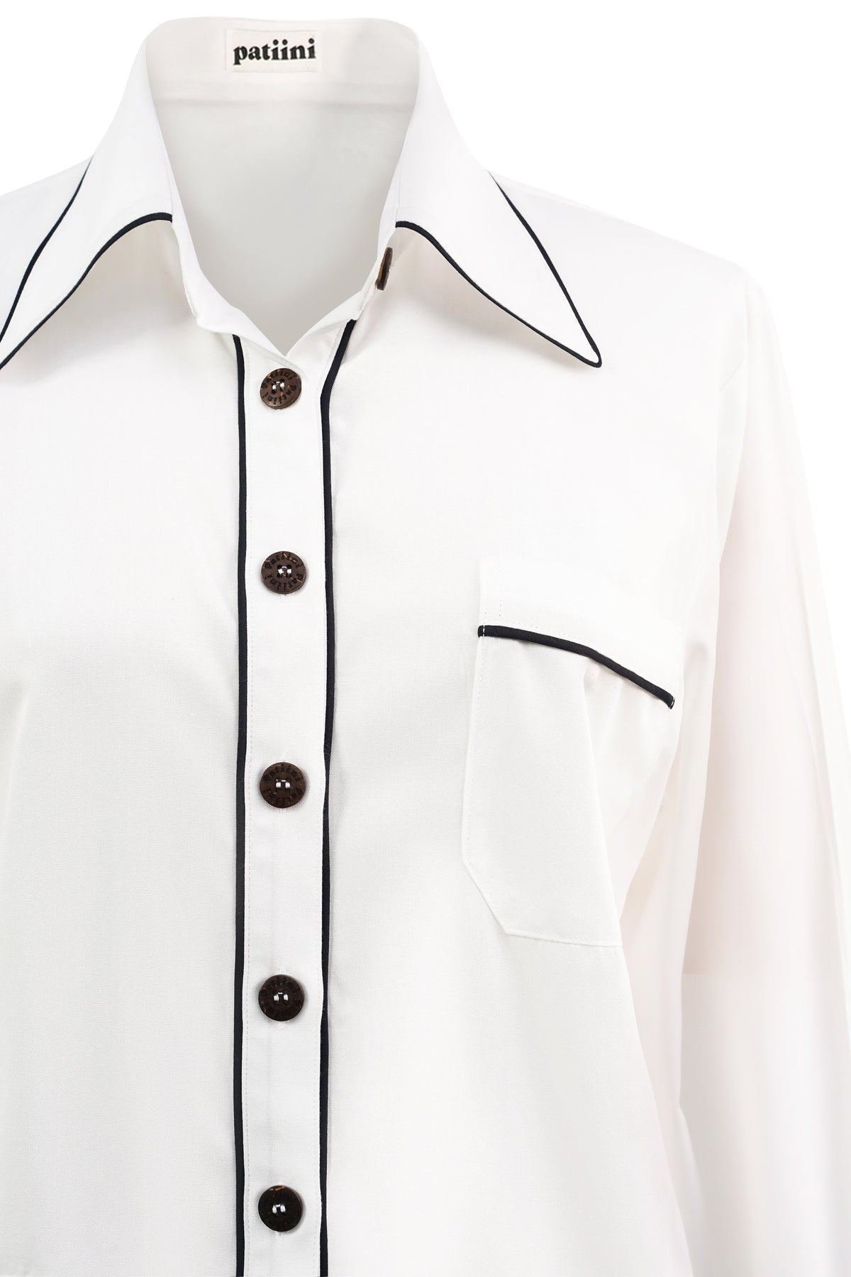 Close-up of white pajama shirt with coconut shell buttons.