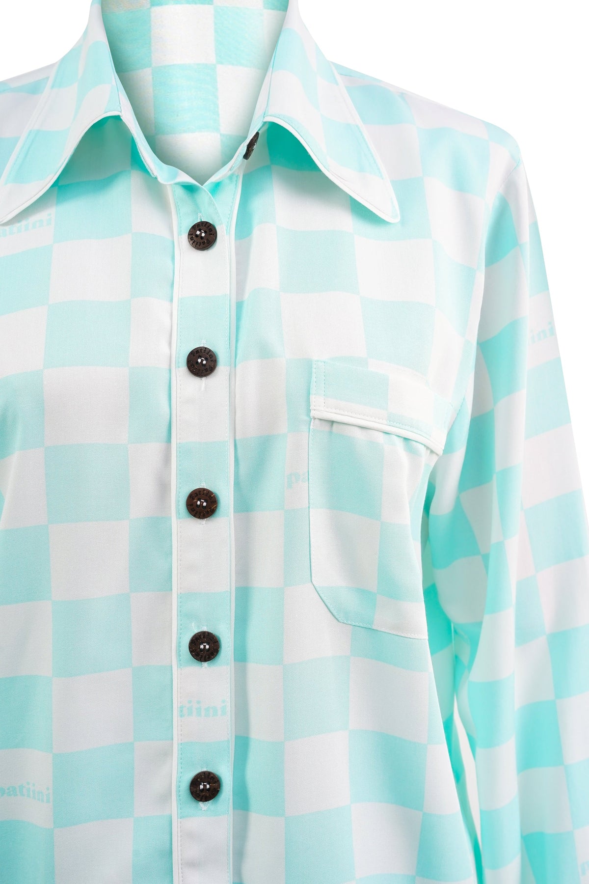 Close up of teal and white checkered pajama set with coconut shell buttons.