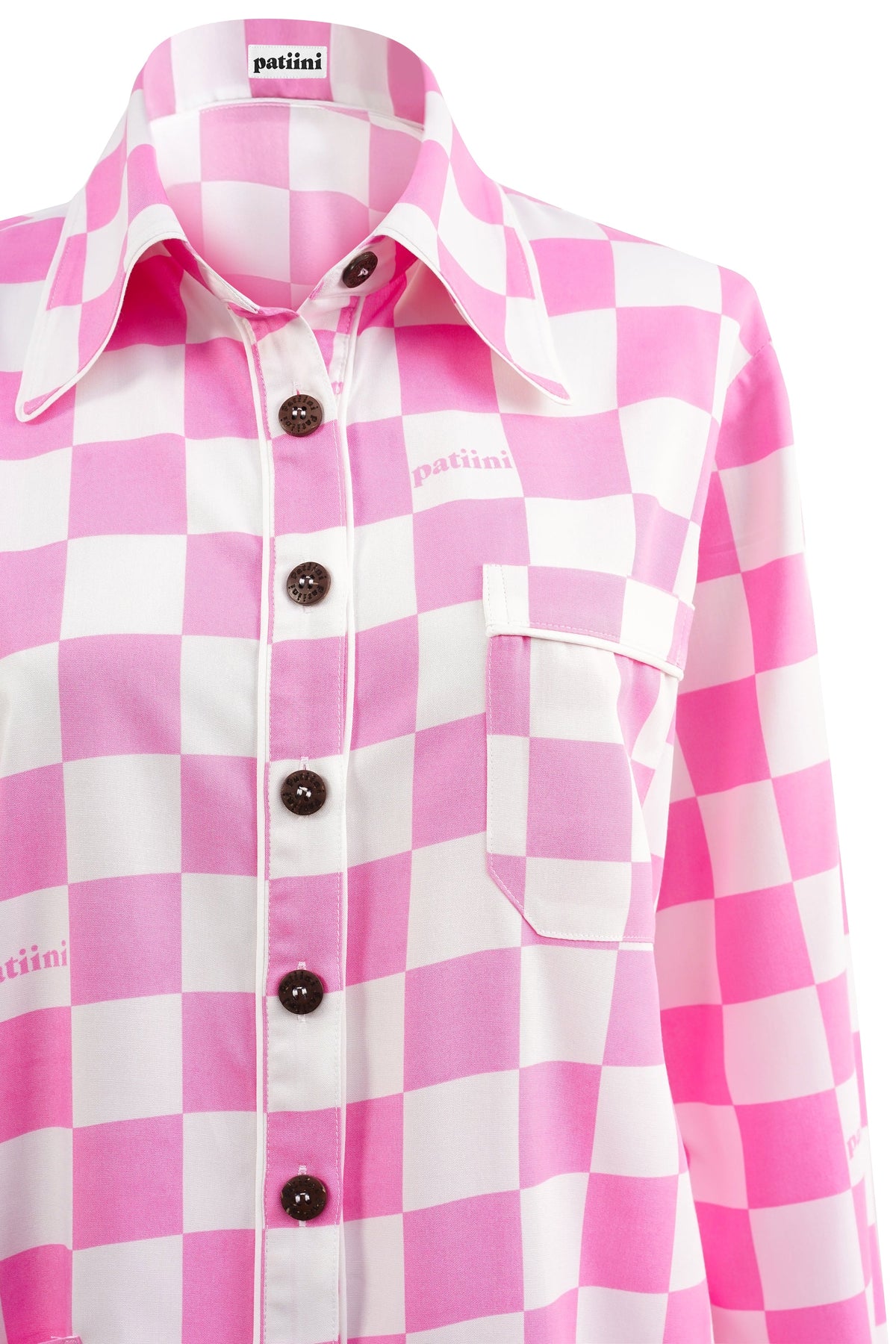 Close up of pink and white checkered pajama shirt with coconut shell buttons.