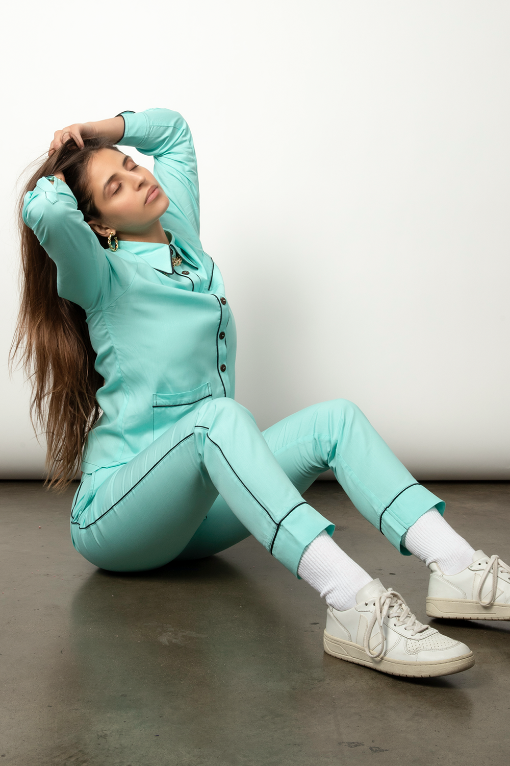 Teal long-sleeved pajama set with contrasting black piping.